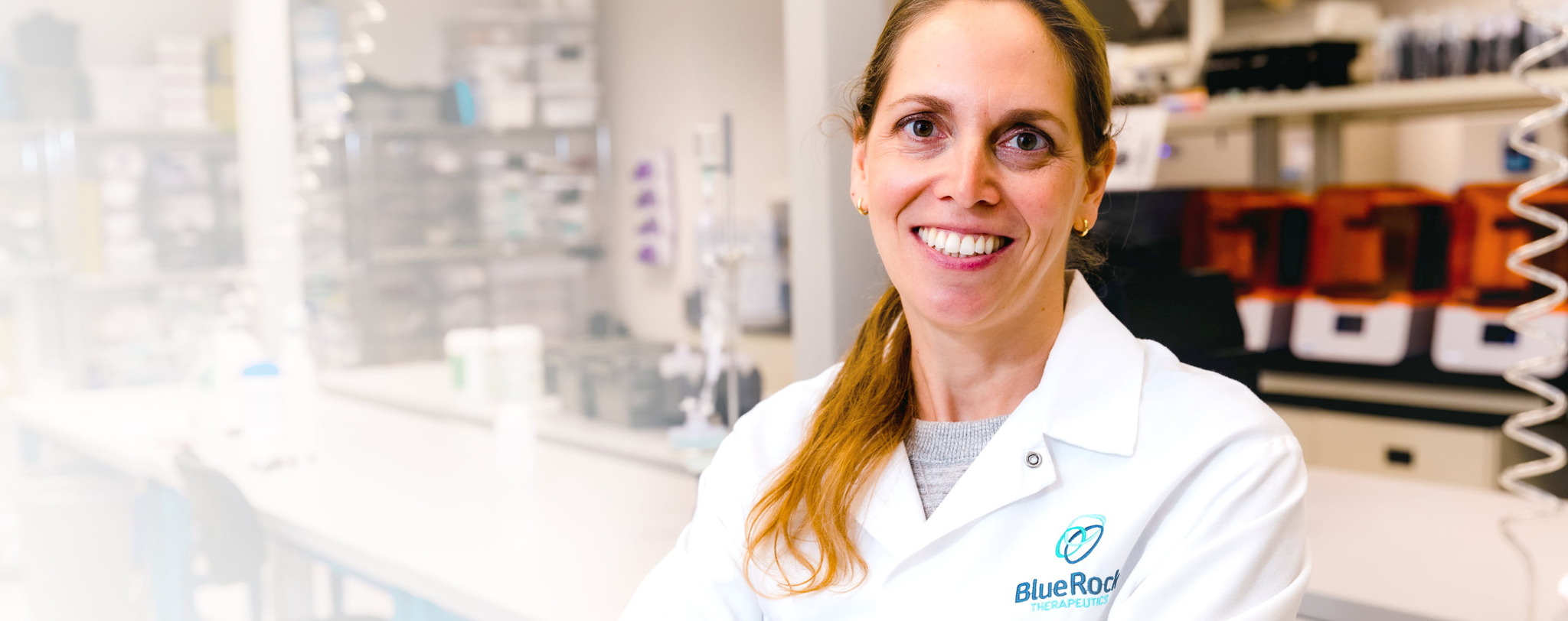 A BlueRock Therapeutics scientist smiling in a lab